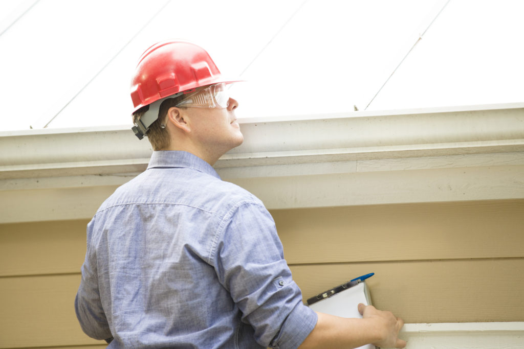 Contractor inspecting metal roofing